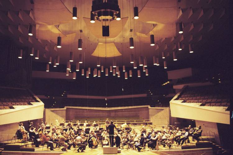 Orchestra playing concert in bandshell